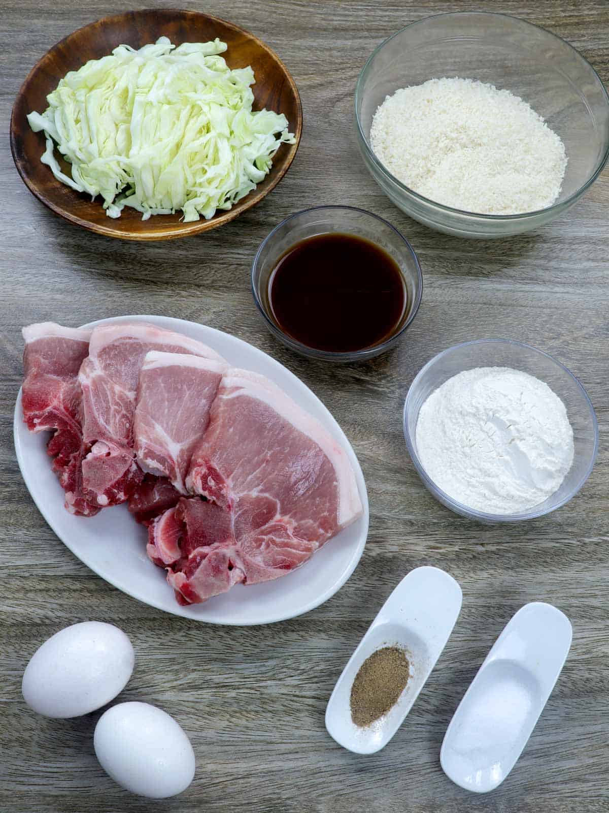 pork chops, flour, panko bread crumbs, eggs, salt, pepper, shredded cabbage