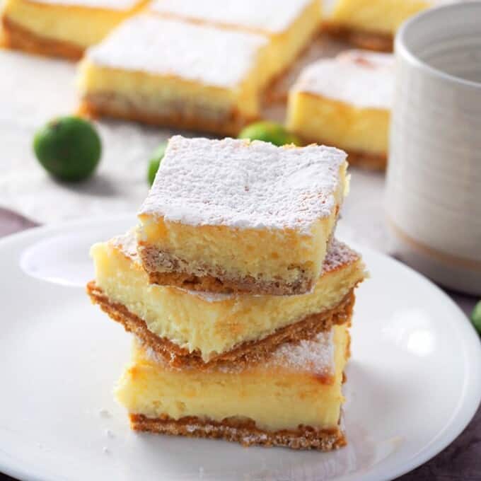 Calamansi Cheesecake Bars stacked on a white plate