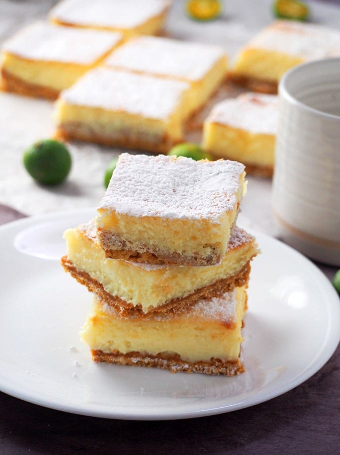 Calamansi Cheesecake Bars stacked on a white plate