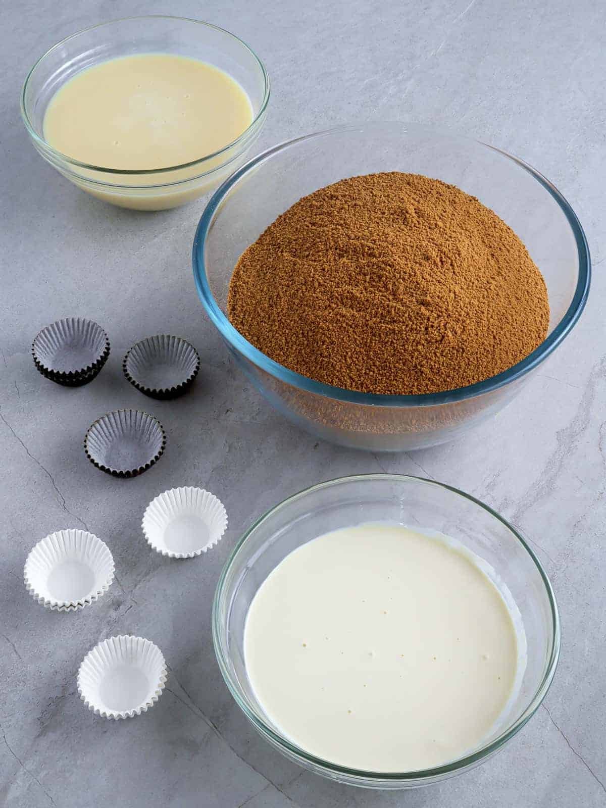 graham cracker crumbs, condensed milk, all-purpose cream in bowls