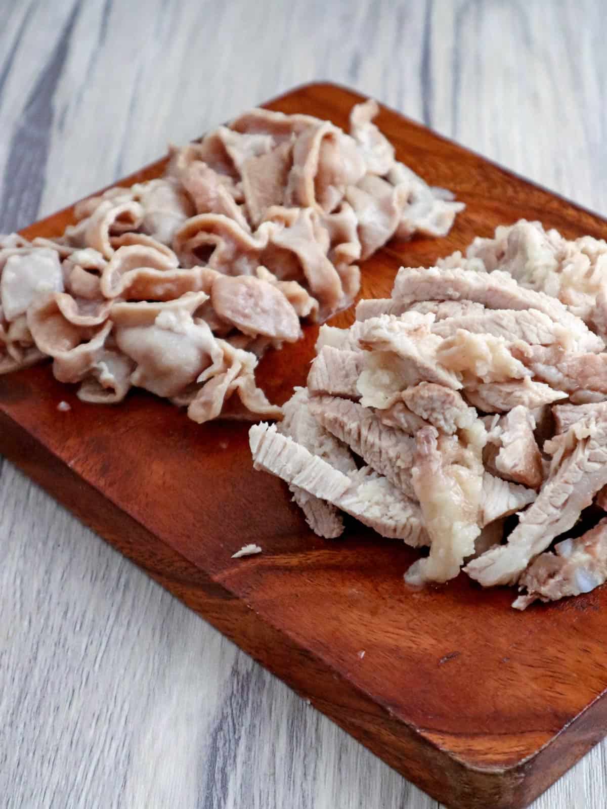 chopped pork meat and innards on a cutting board