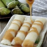 suman malagkit drizzled with coconut caramel sauce on a serving plate