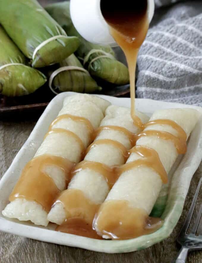 suman malagkit drizzled with coconut caramel sauce on a serving plate