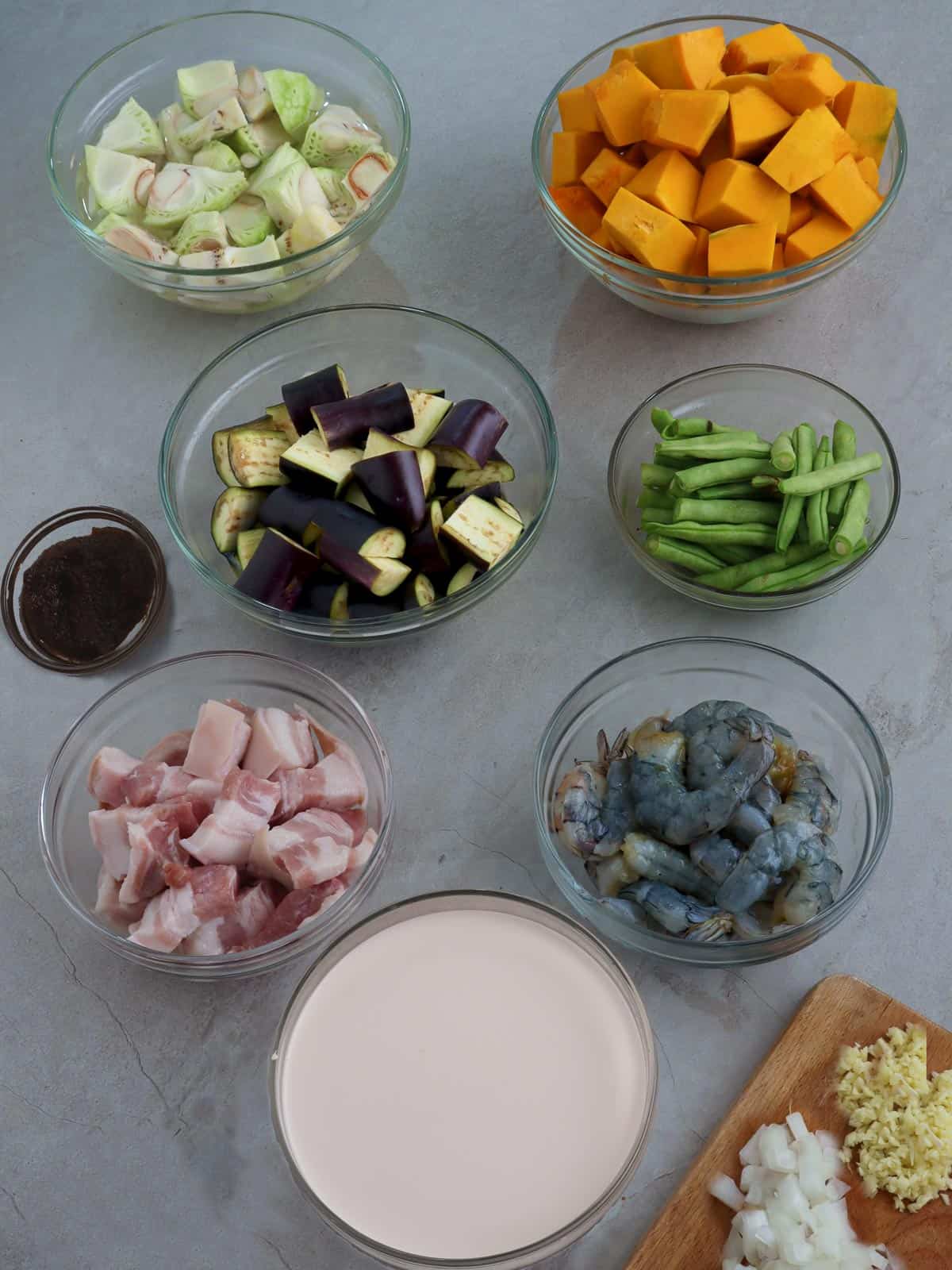 chopped onions, garlic, coconut milk, kalabasa, eggplant, green jackfruit, green beans, shrimp, diced pork