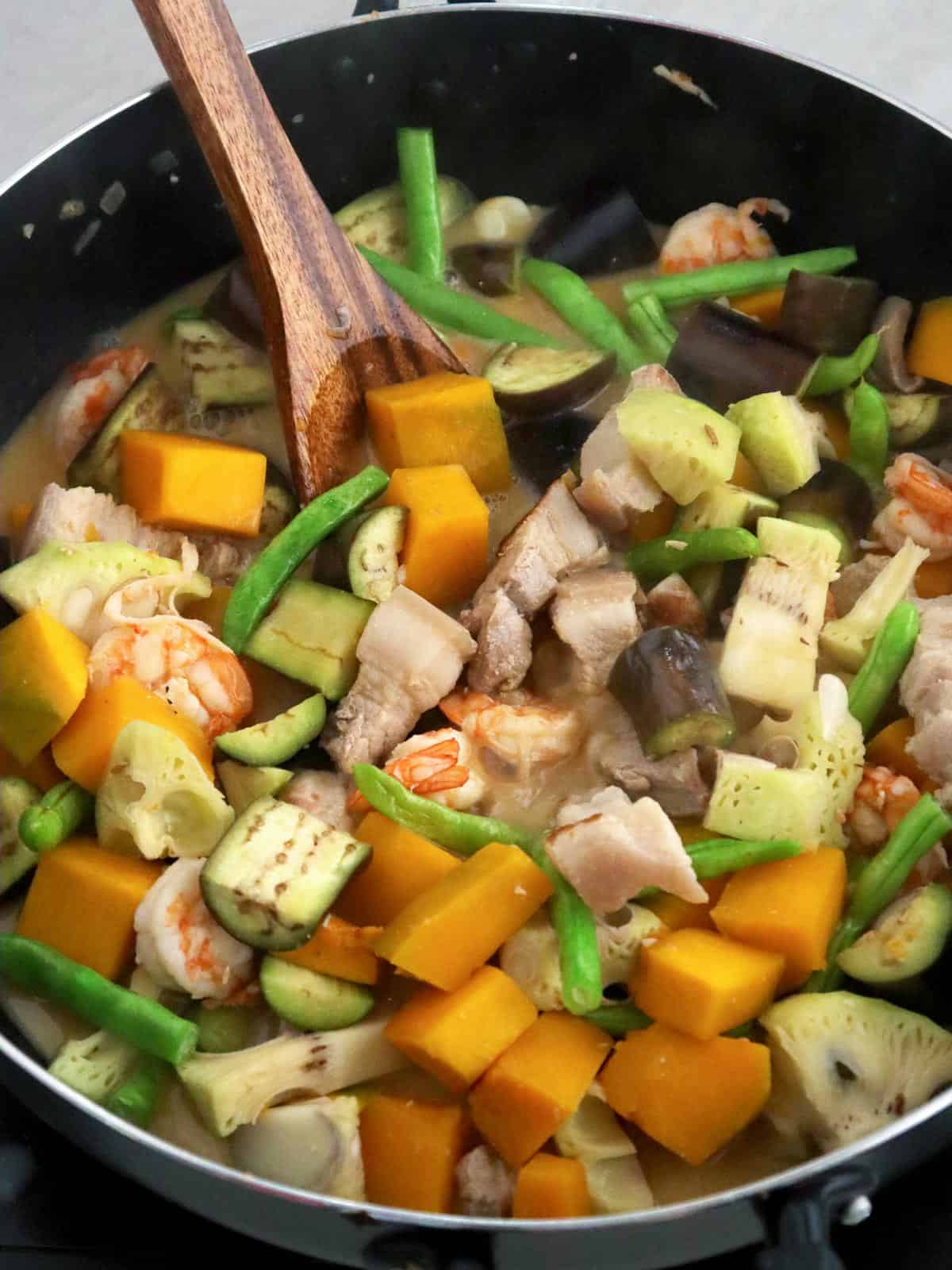 creamy vegetable stew in coconut cream with pork and shrimp in a pan