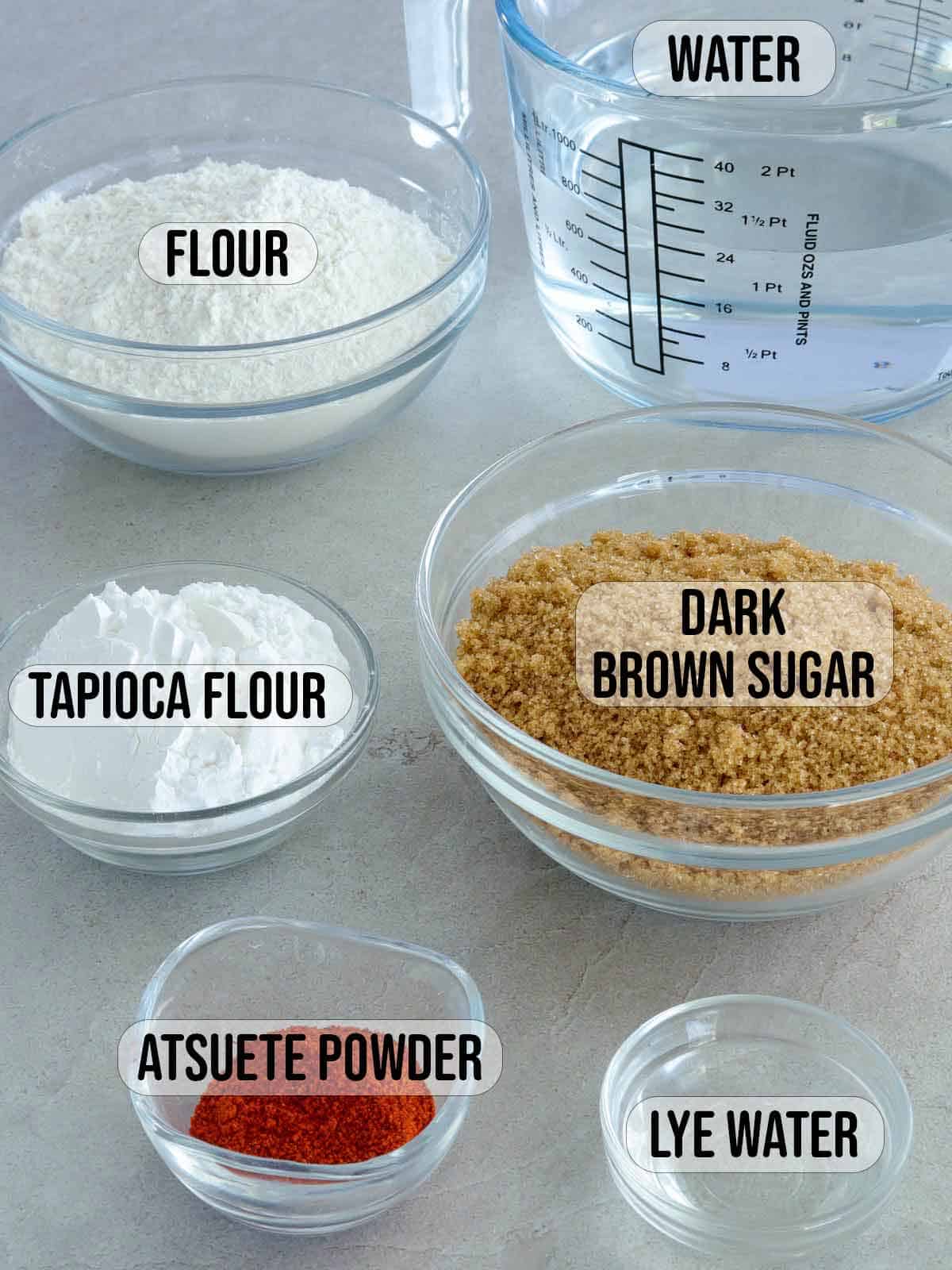 flour, tapioca flour, atsuete powder, brown sugar, lye water, water in bowls.