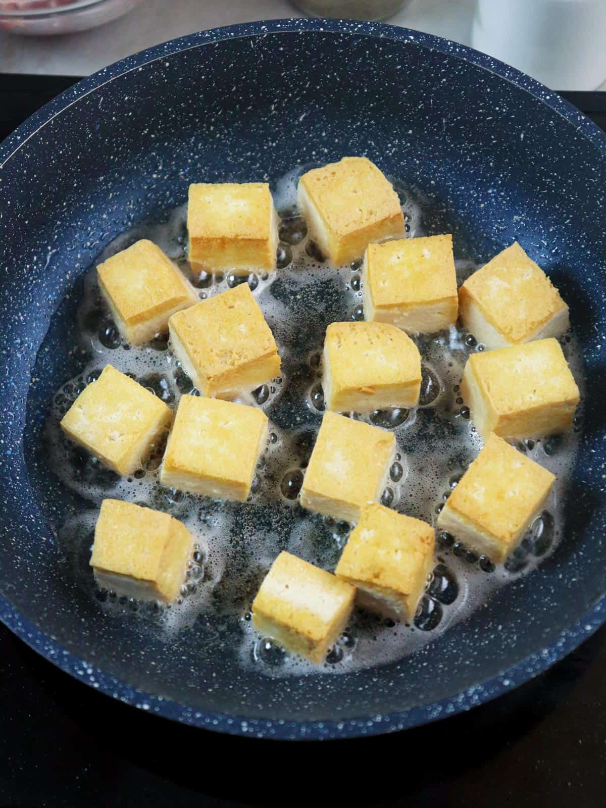 frying tofu in a pan