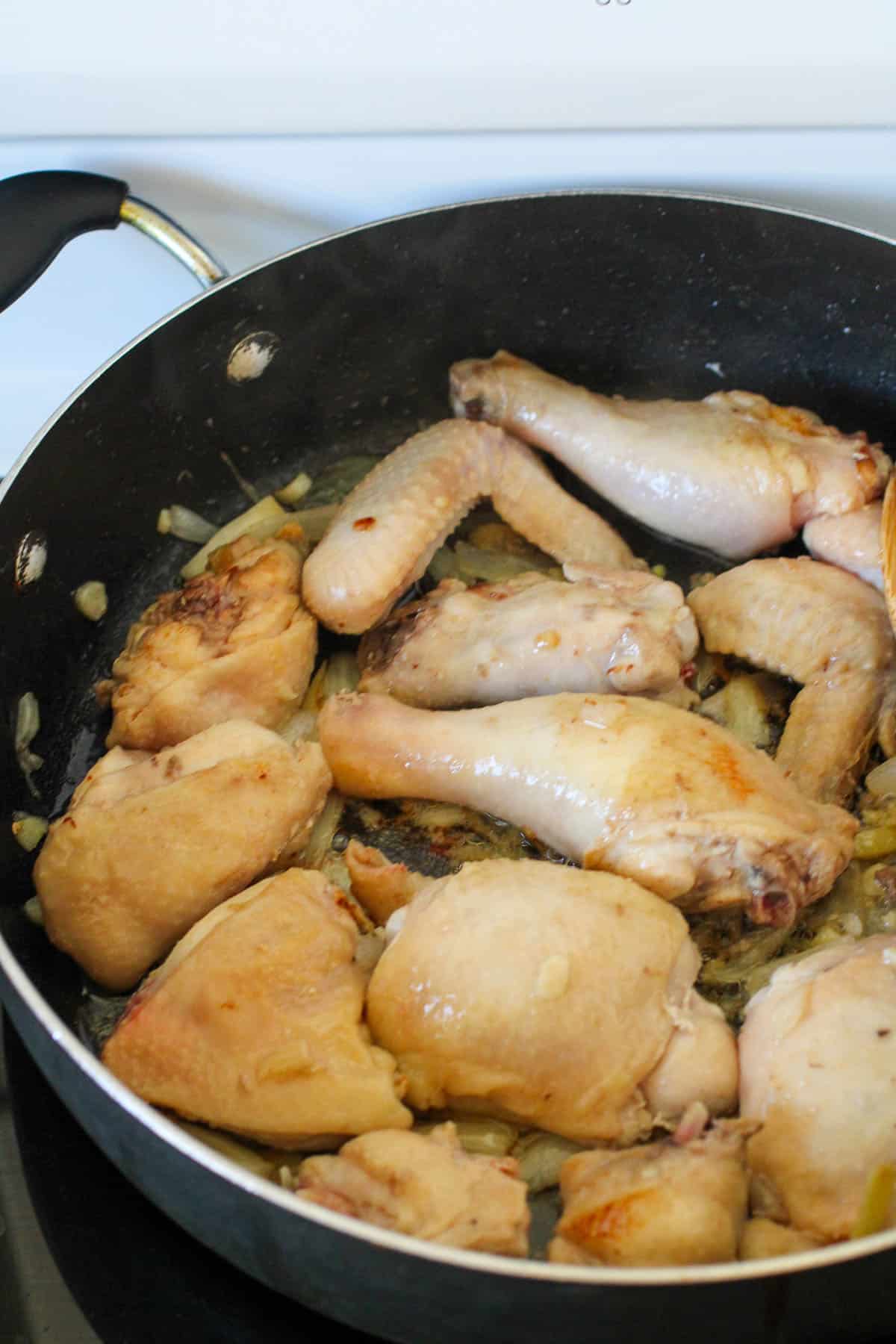 sauteing chicken in a pan