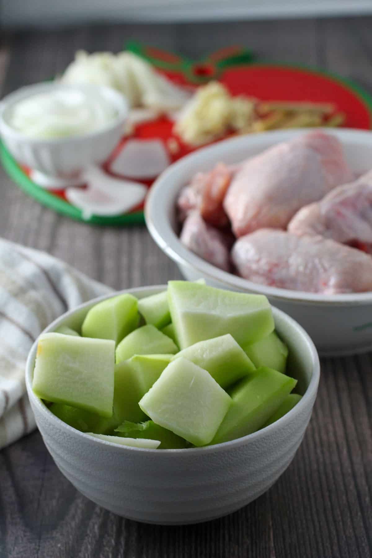 cut up chicken, papaya, coconut, ginger, onions, garlic