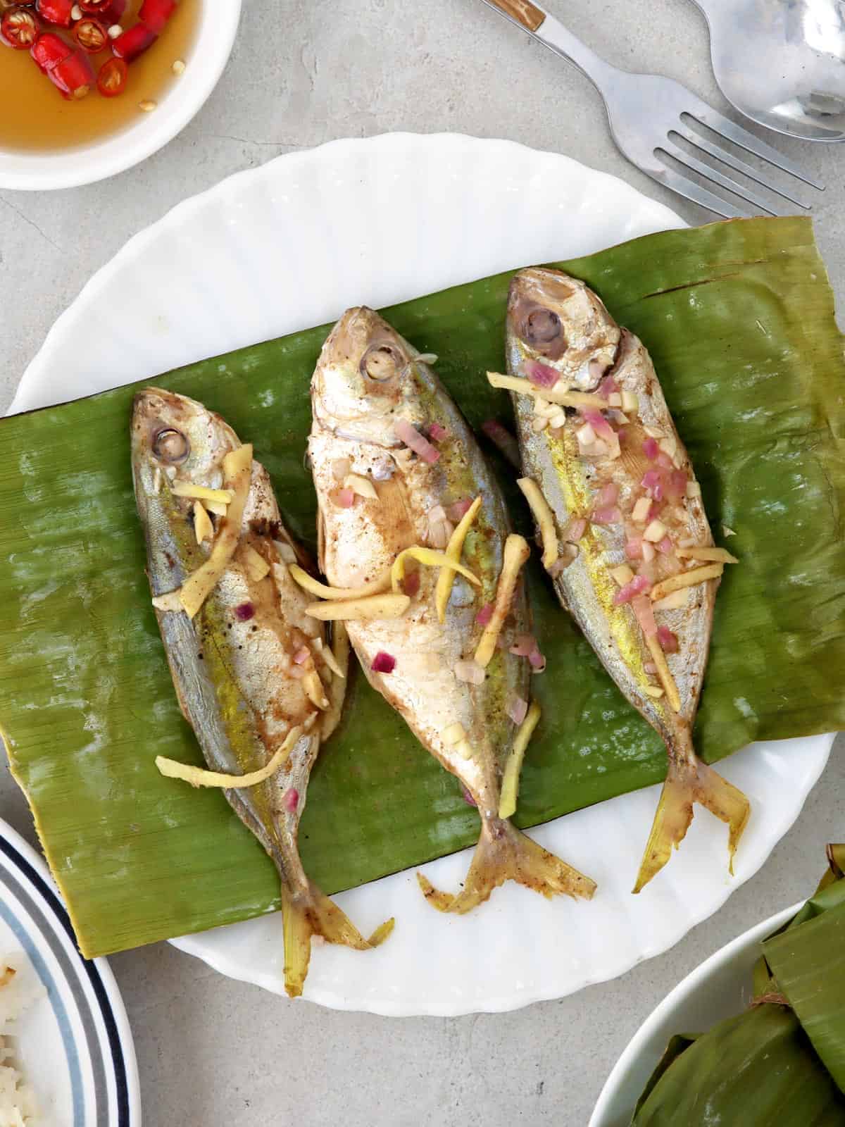 Banana-wrapped Salay-Salay Fish on a white plate