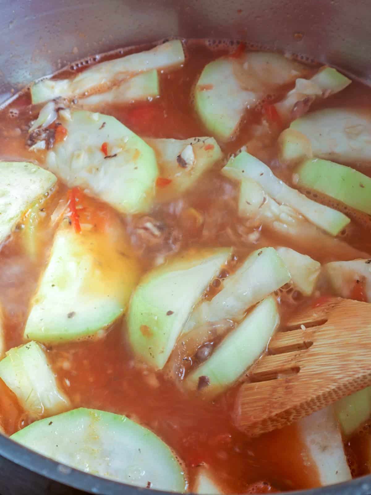 cooking upo with canned sardines in a pot