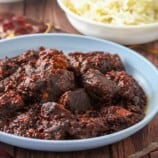 Mexican adobo in a blue serving bowl