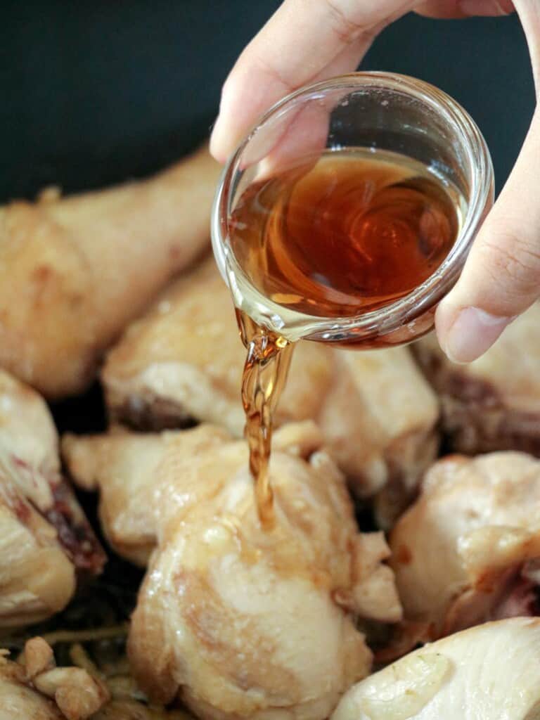 pouring fish sauce to chicken stew