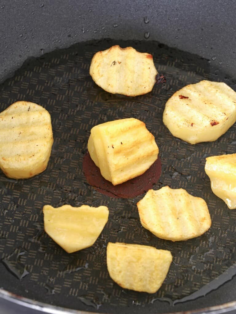 pan-frying potatoes in a pan