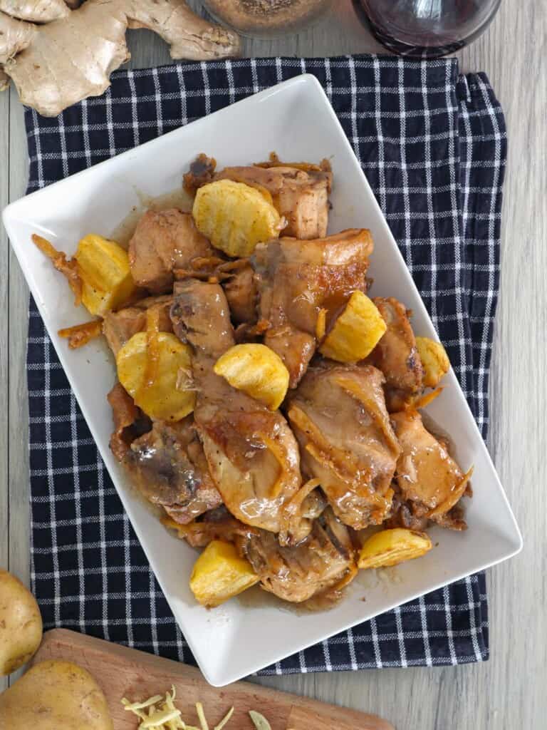 Stewed Chicken with potatoes on a white platter