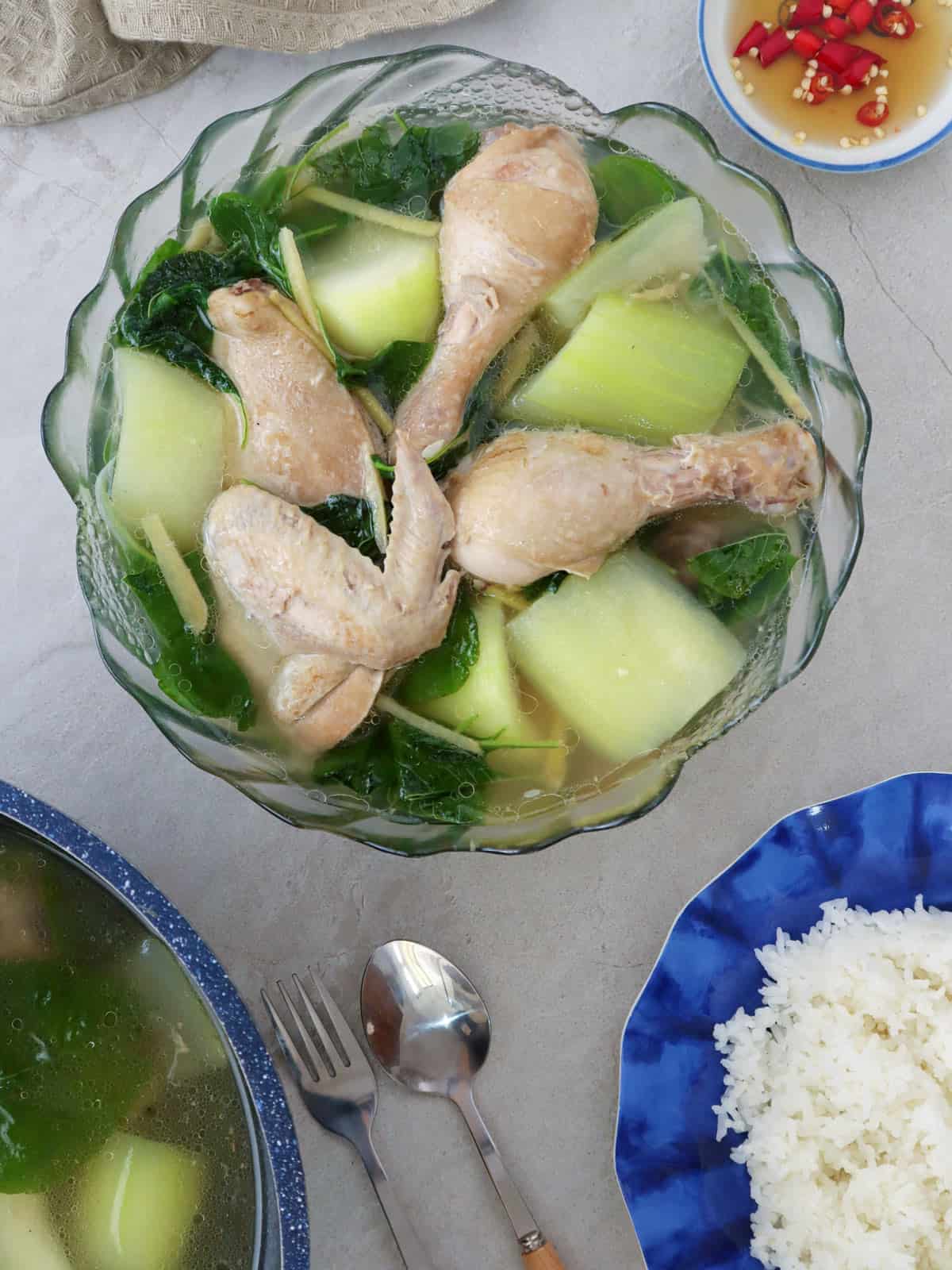 Tinolang Manok sa Upo in a bowl with a plate of steamed rice on the side