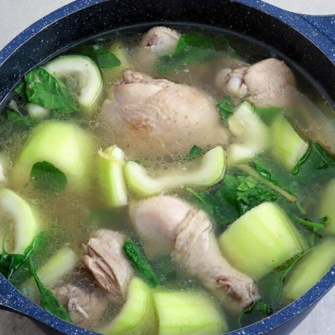 chicken tinola with upo and spinach in a pot