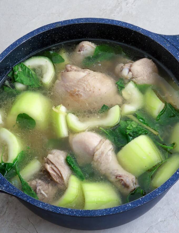 chicken tinola with upo and spinach in a pot