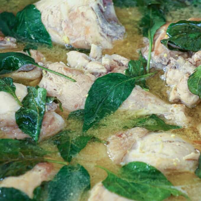 Filipino chicken soup with fish sauce and chili leaves in a pot