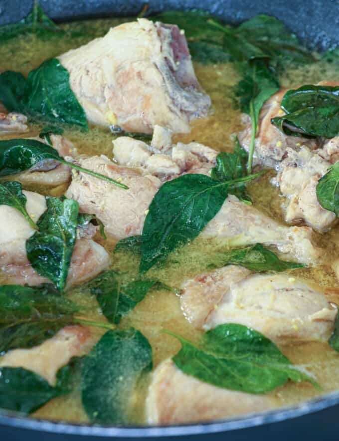 Filipino chicken soup with fish sauce and chili leaves in a pot