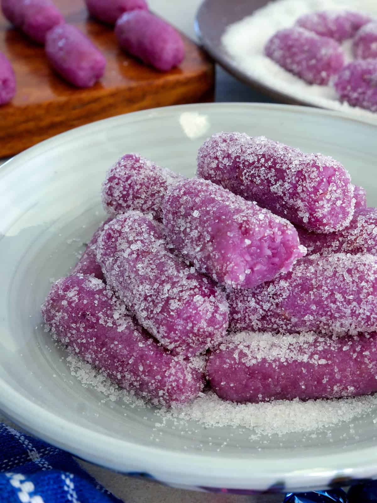 ube pastillas coasted with sugar on a plate