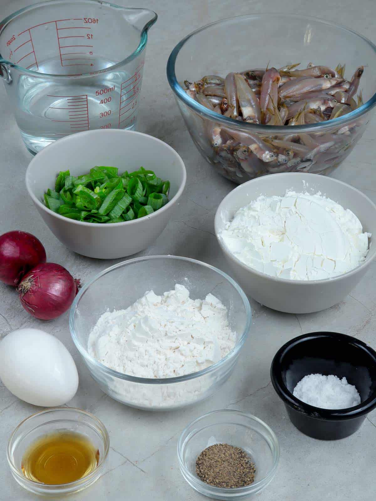 anchovies, green onions, shallots, flour, cornstarch, water, egg, fish sauce, salt, pepper in bowls