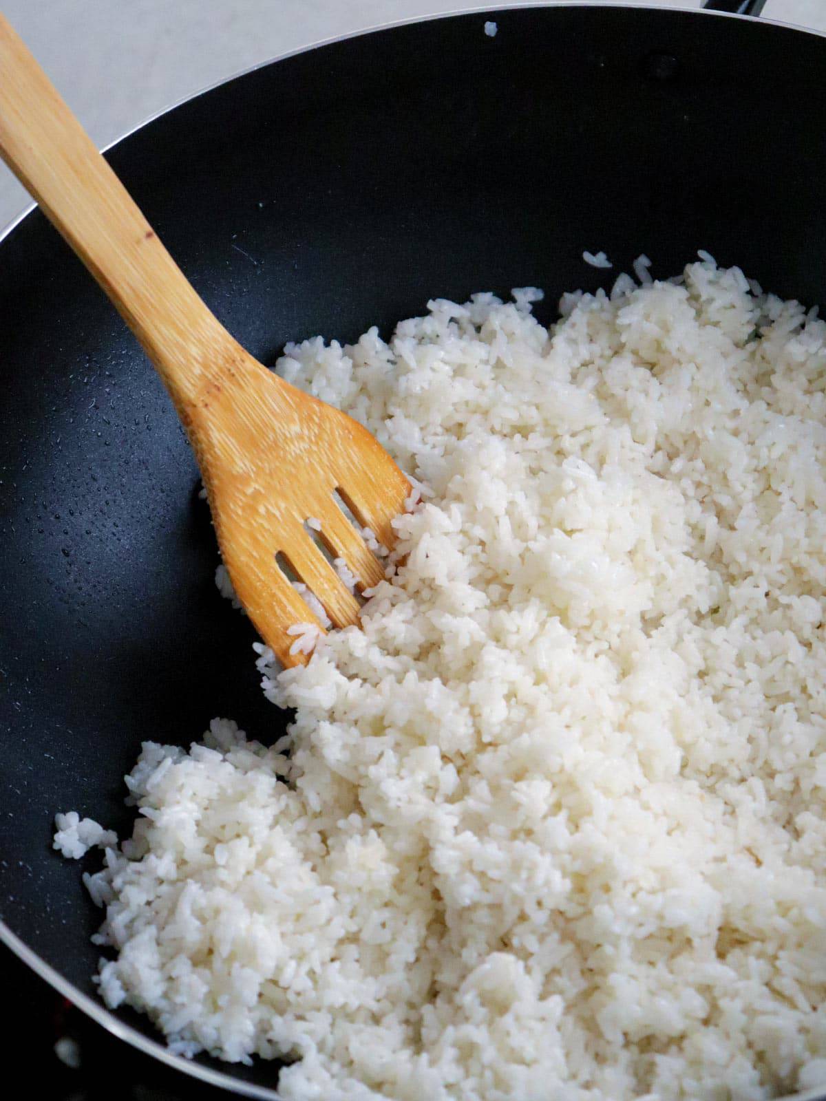 making garlic fried rice in a wok