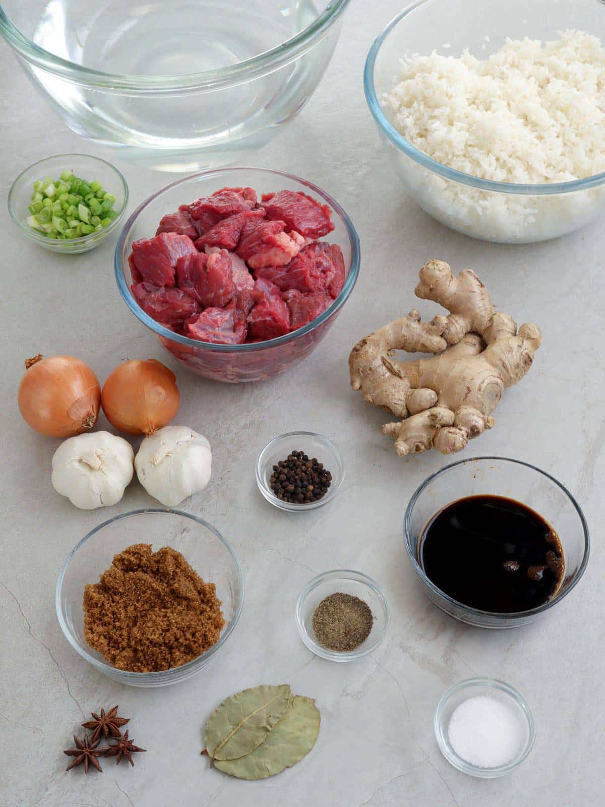 beef cubes, ginger, onions, garlic, brown sugar, soy sauce, water, steamed rice, bay leaves