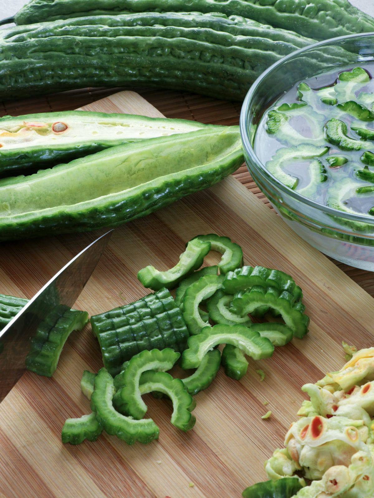 slicing ampalaya on a cutting board