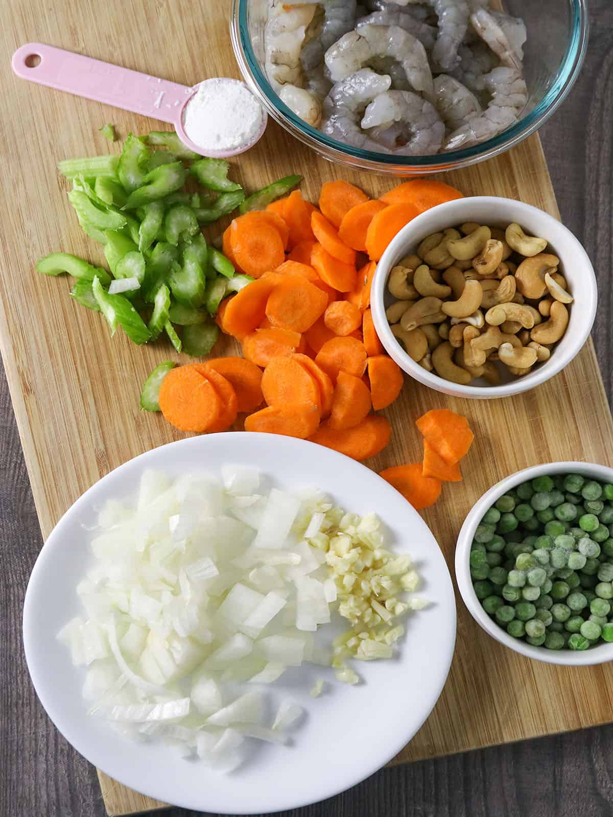 chopped onions, minced garlic, green peas, celery, sliced carrots, peeled shrimp, cornstarch