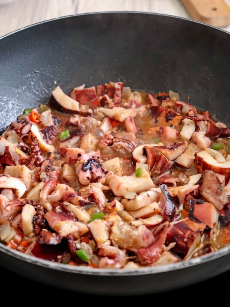 cooking pusit na sisig in a pan