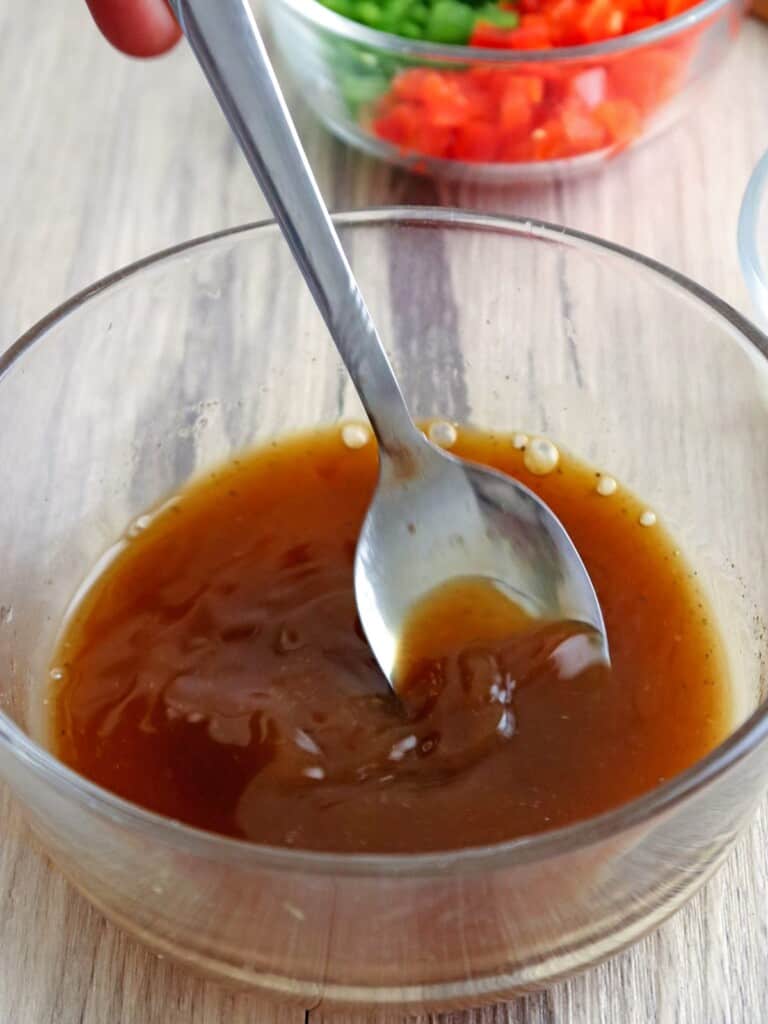 mixing sisig pusit sauce in a bowl