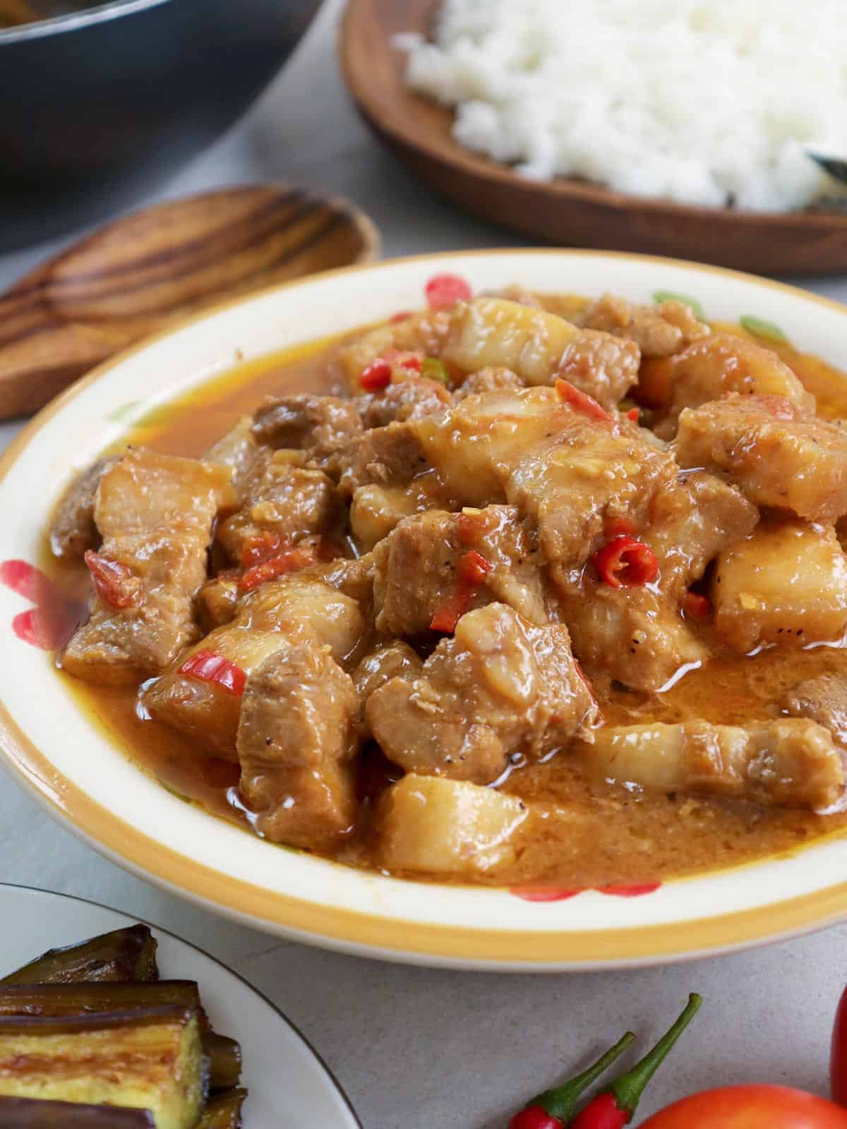 Binagoongan Baboy sa Gata in a white serving bowl