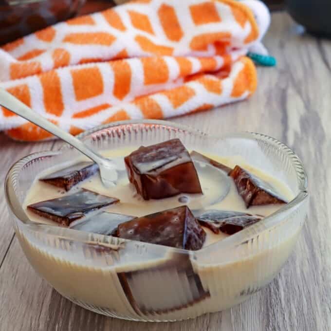 eating coffee jelly with a spoon in a bowl