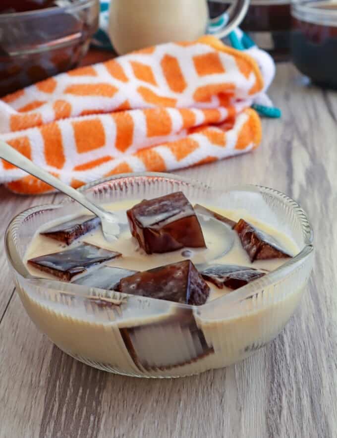 eating coffee jelly with a spoon in a bowl