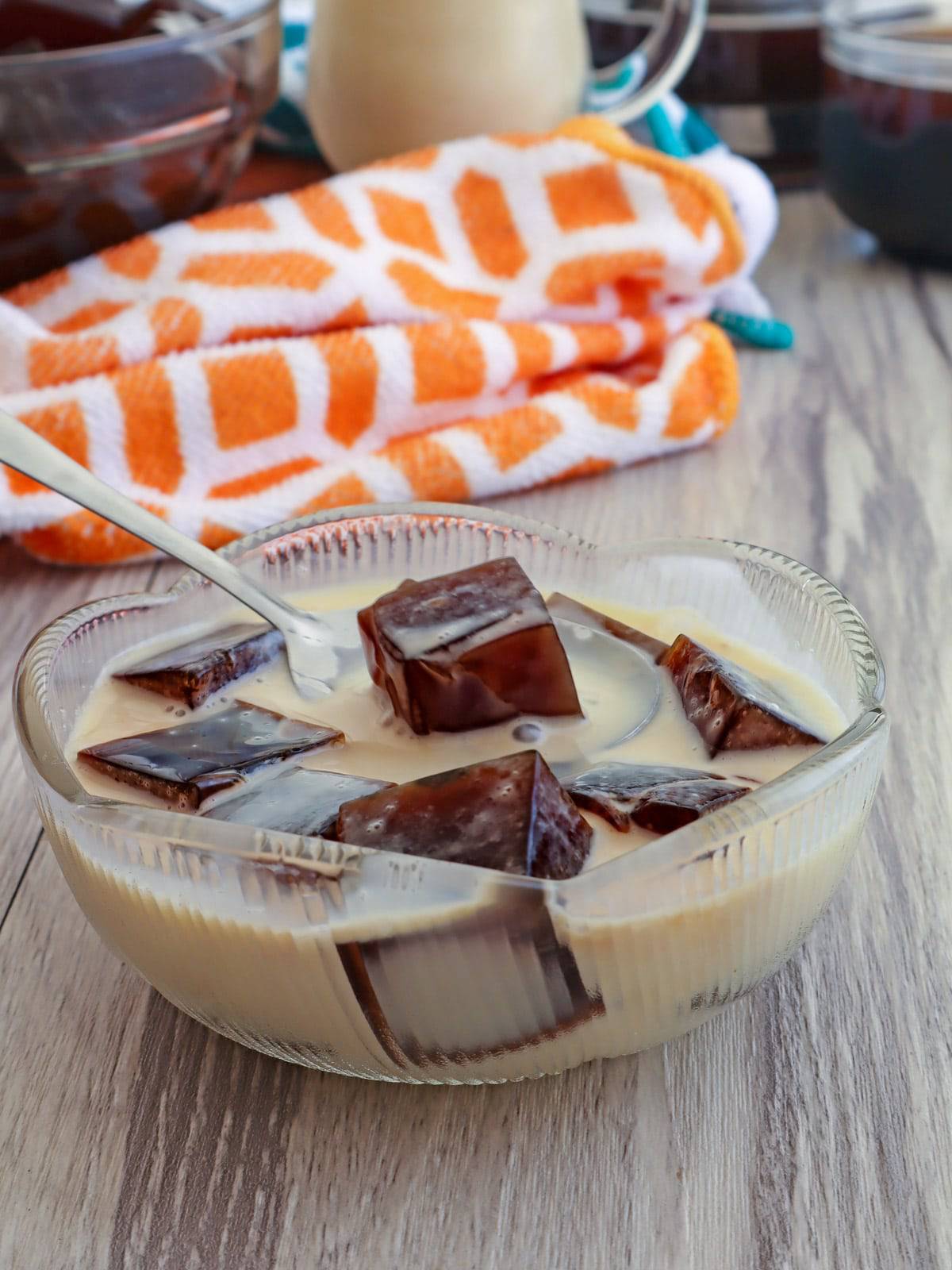 eating coffee jelly with a spoon in a bowl