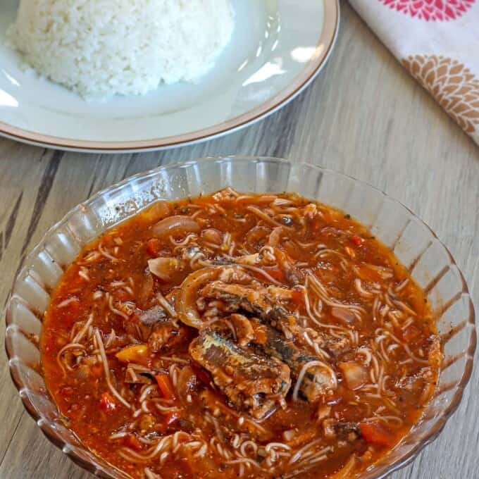 Ginisang Sardinas at Miswa in a clear bowl with a plate of steamed rice on the side