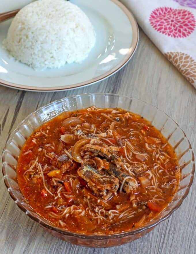 Ginisang Sardinas at Miswa in a clear bowl with a plate of steamed rice on the side