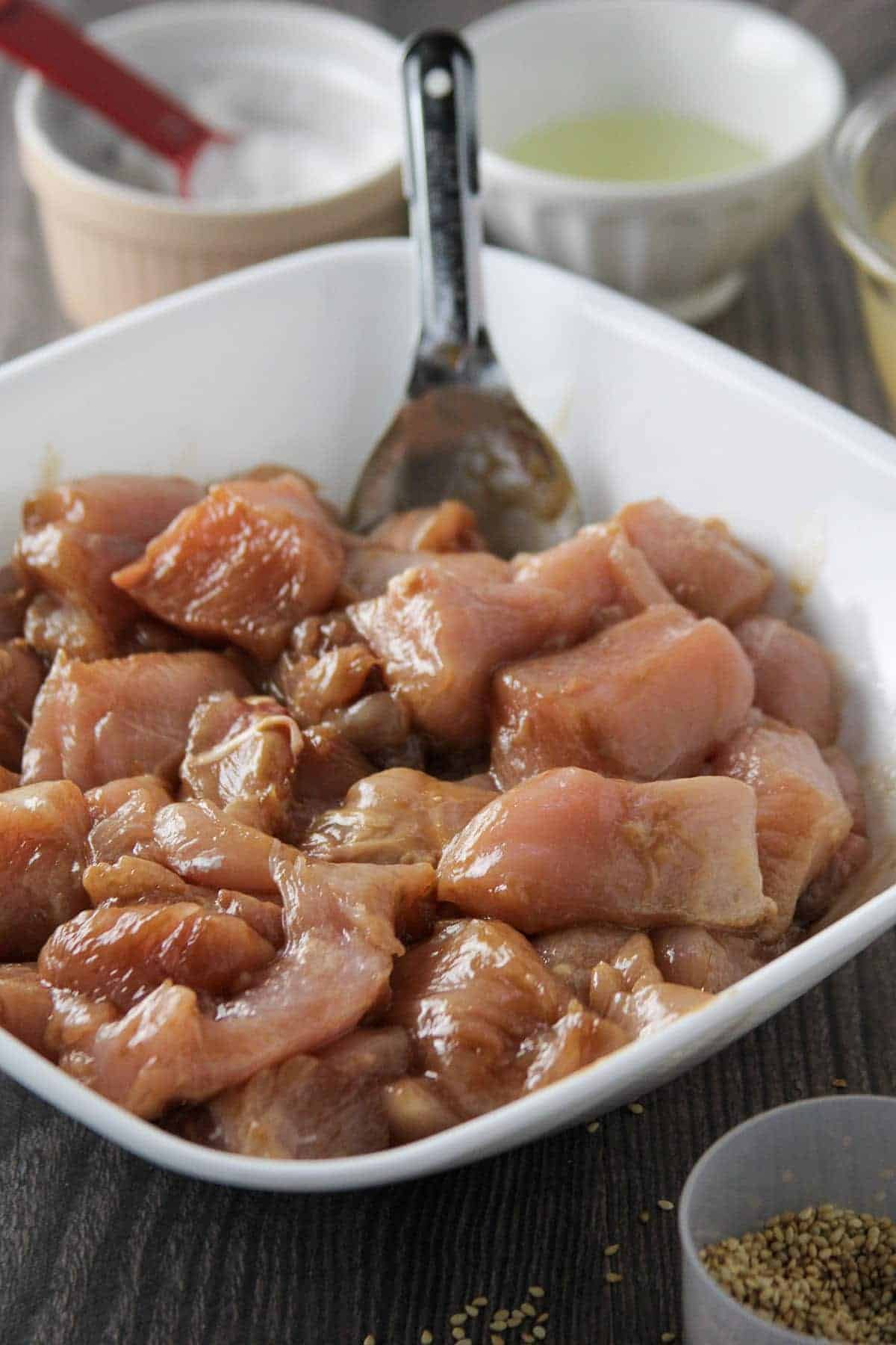 marinating cut-up chicken breast in a bowl