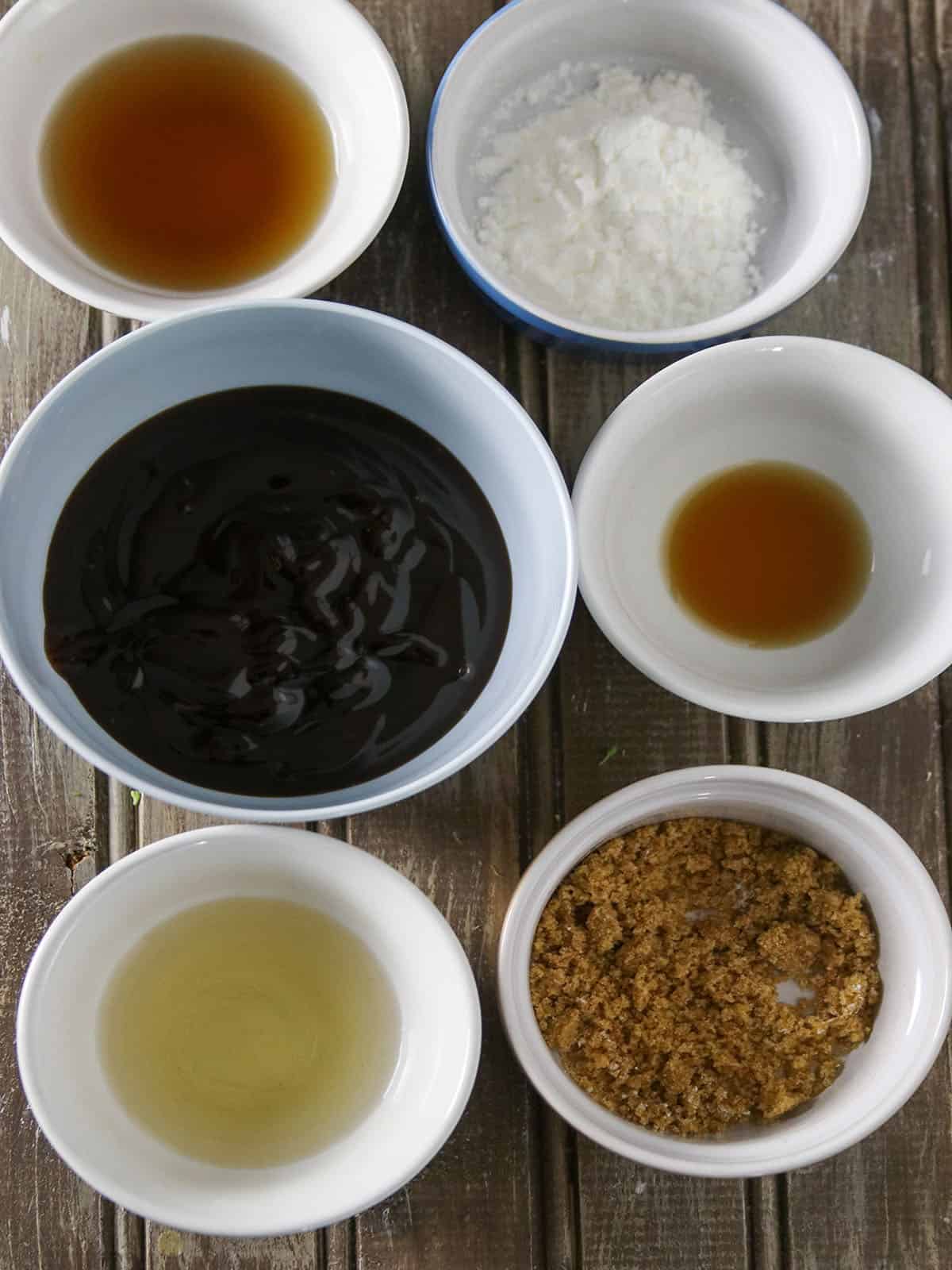 soy sauce, sesame oil, oyster sauce, cornstarch, rice vinegar, Chinese cooking wine in white small bowls