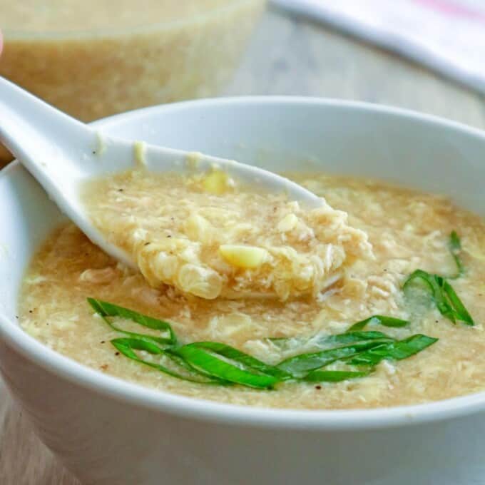 eating Chicken Corn Soup from a white bowl