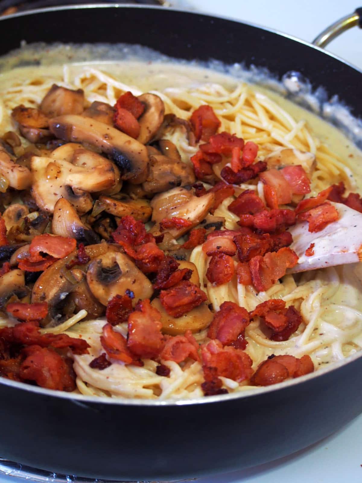 cooking spaghetti carbonara in a skillet