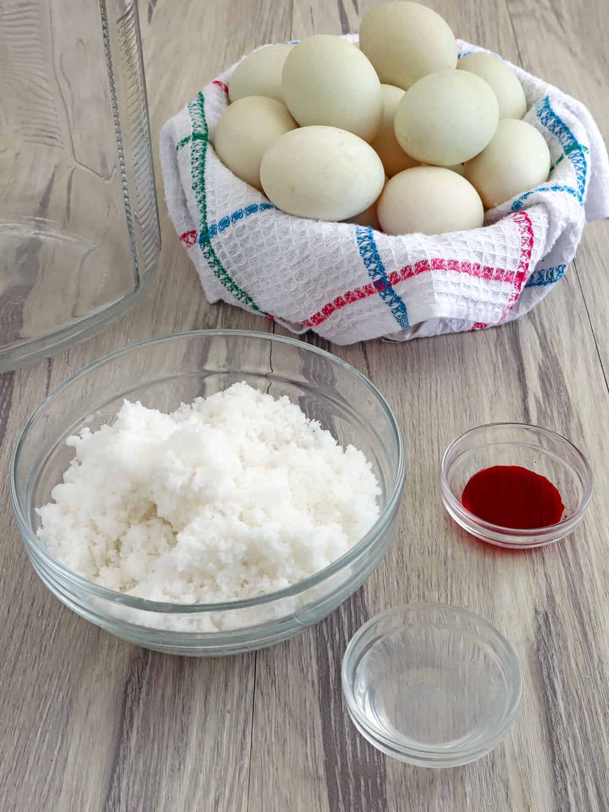 duck eggs, salt, water, vinegar, and red food coloring in individual bowls