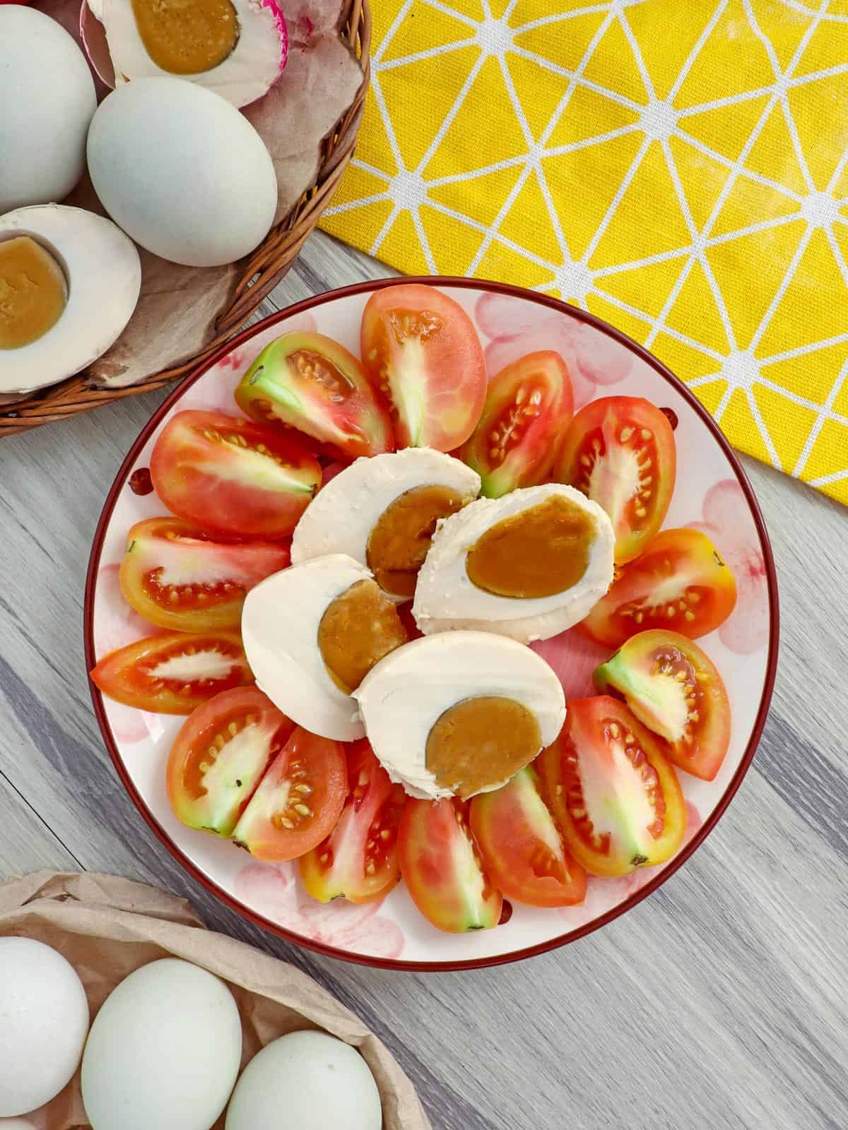 sliced tomatoes and itlog na maalat on a serving platter