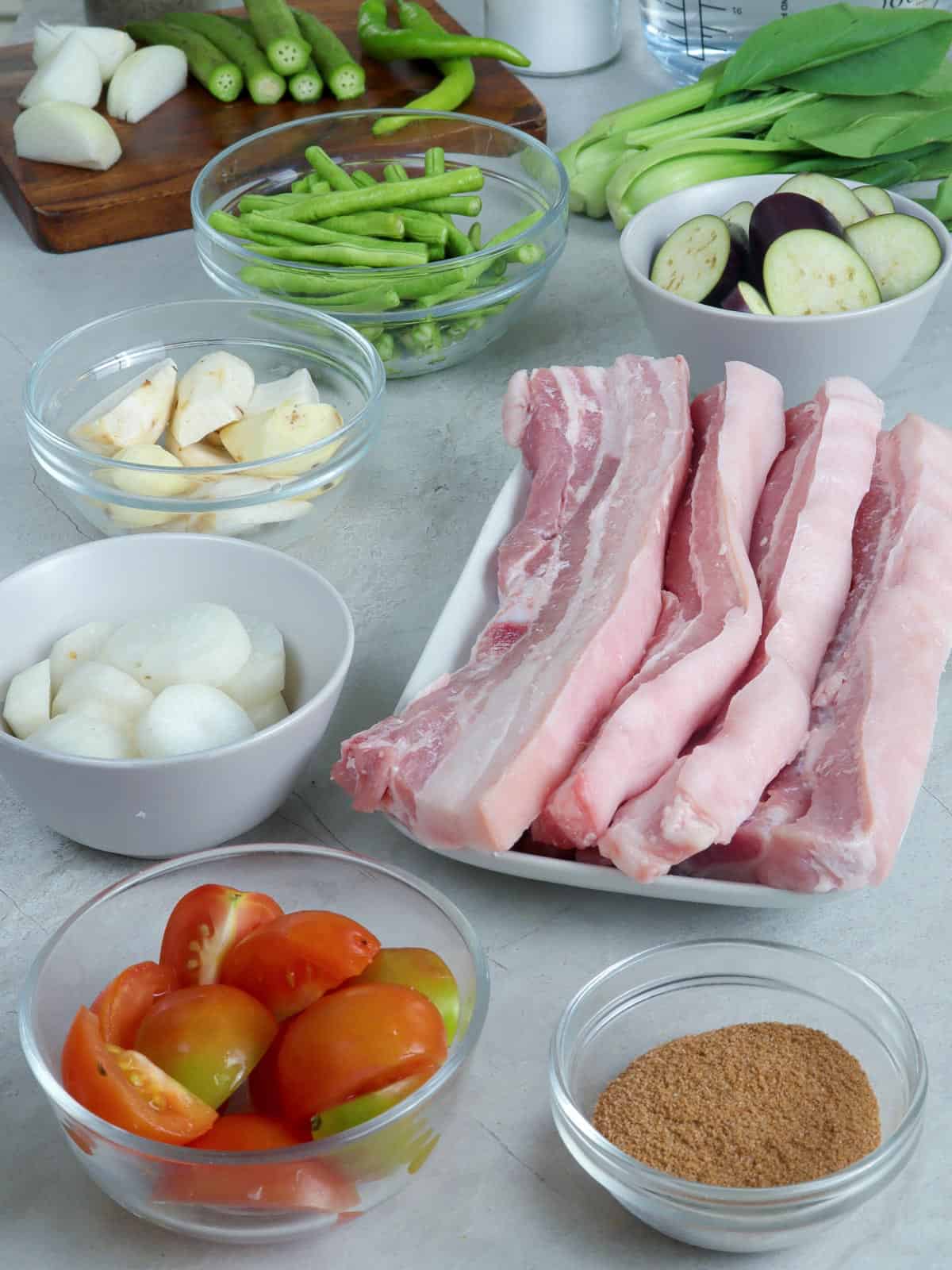 pork belly strips, pechay, eggplant, onions, tomatoes, gabi, tamarind powder, okra, sitaw, radish