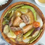 Sinigang na Inihaw na Liempo in a wooden serving bowl