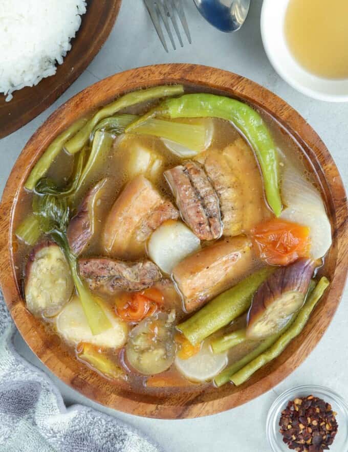 Sinigang na Inihaw na Liempo in a wooden serving bowl