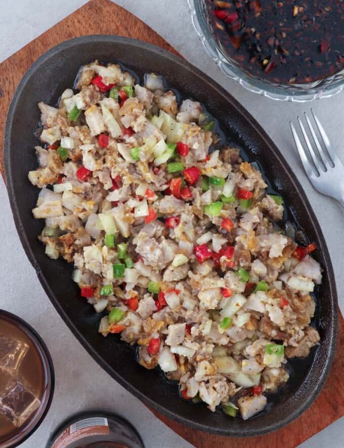 crispy sisig on a sizzling plate