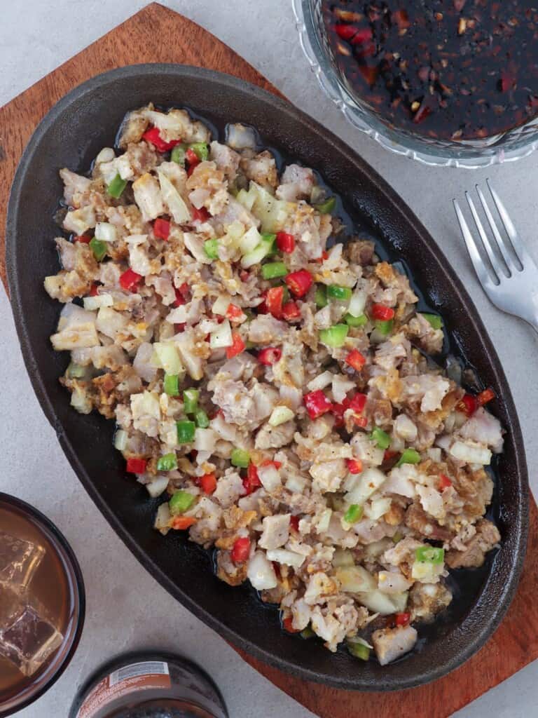 crispy sisig on a sizzling plate