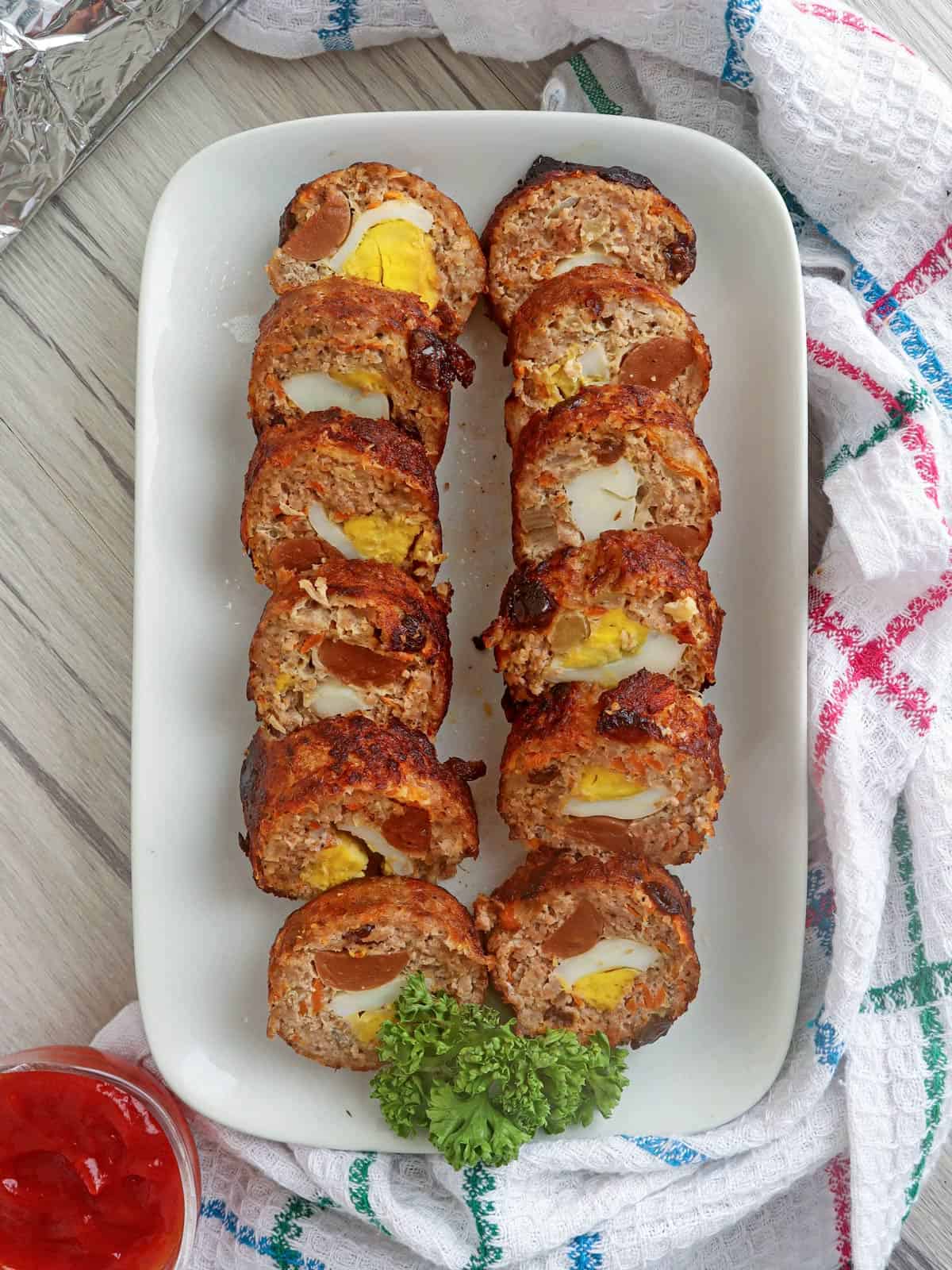 sliced pork embutido on a serving platter